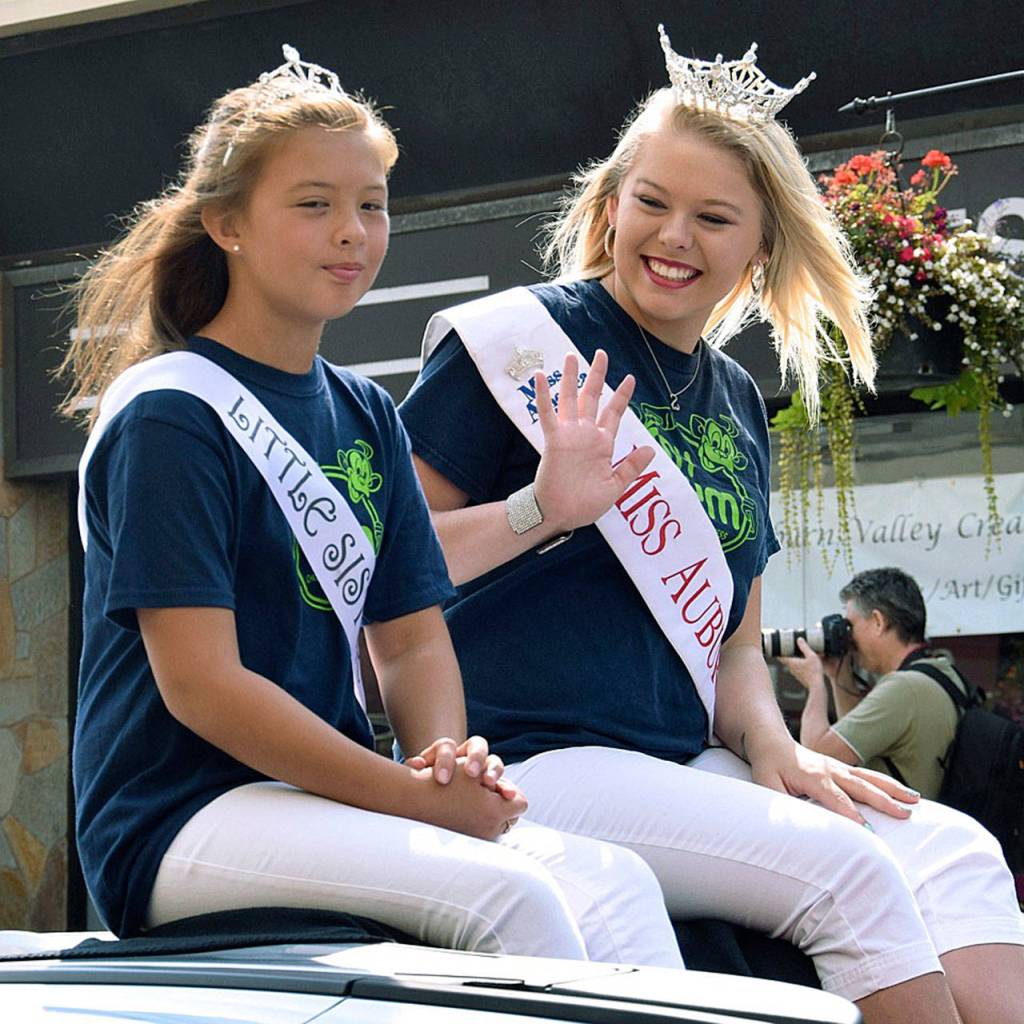 Miss Auburn, Heather Haggin, with her Little Sister, Katie Fernandez, waves to the crowd. RACHEL CIAMPI, Auburn Reporter