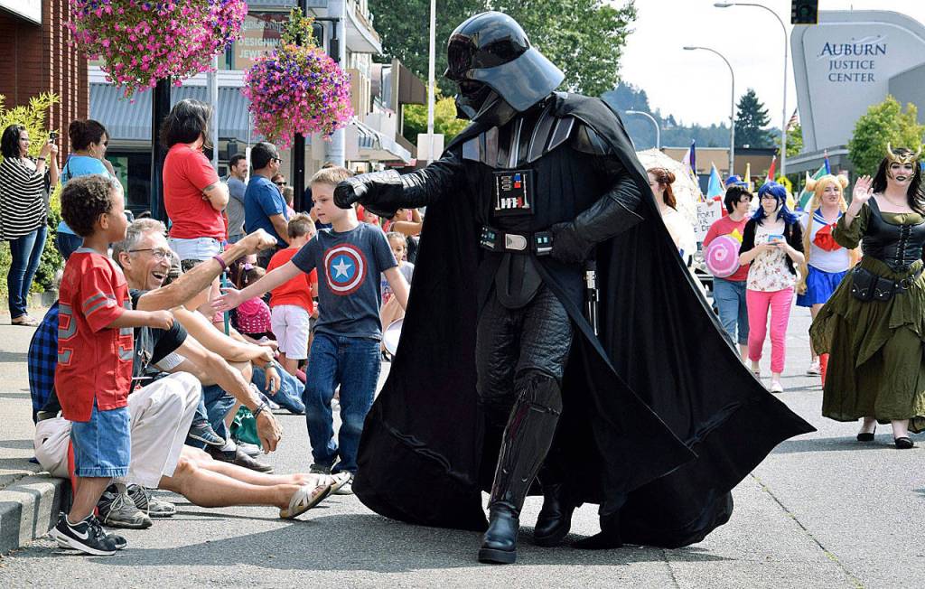 Darth Vader gives high-fives to kids along the parade route. RACHEL CIAMPI, Auburn Reporter