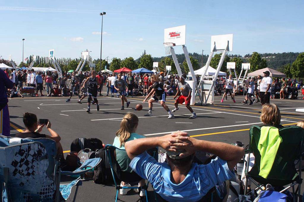 Fans grab a court-side spot to view the action. MARK KLAAS, Auburn Reporter