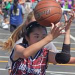 Jade Fajarillo, of the Lady Outlaws of Lynnwood, tries to collect a loose ball during in fifth-grade girls play. MARK KLAAS, Auburn Reporter