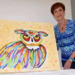 Ronie Schwend shows her painting, &lsquo;Hooo&rsquo;s Ready For School&rsquo; at The Outlet Collection art party. RACHEL CIAMPI, Auburn Reporter