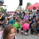Kids crawl and move to the music of Chris Ballew at the Auburn Farmers Market on Sunday. Ballew, a former lead singer and &lsquo;basitarist&rsquo; of the alternative rock group The Presidents of the United States of America, performs as a children&rsquo;s artist under the pseudonym Caspar Babypants. RACHEL CIAMPI, Auburn Reporter