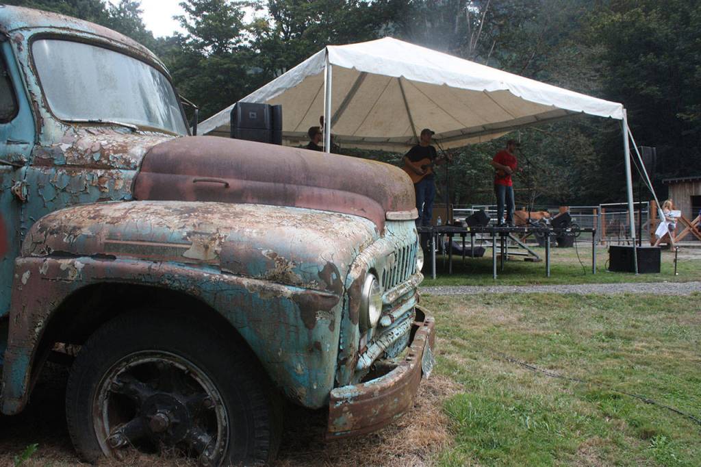 A vintage truck looks on as the music blares from stage. MARK KLAAS, Auburn Reporter