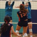 Auburn Riverside&rsquo;s Brianna Ingram, left, and Kate Pestova apply a wall to stop Kennedy Catholic hitter Haley Moore during NPSL volleyball play Wednesday night. RACHEL CIAMPI, Auburn Reporter