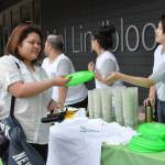 Joy Chang, right, hands a student a frisbee during a Welcome Week giveaway on Monday. HEIDI SANDERS, Kent Reporter