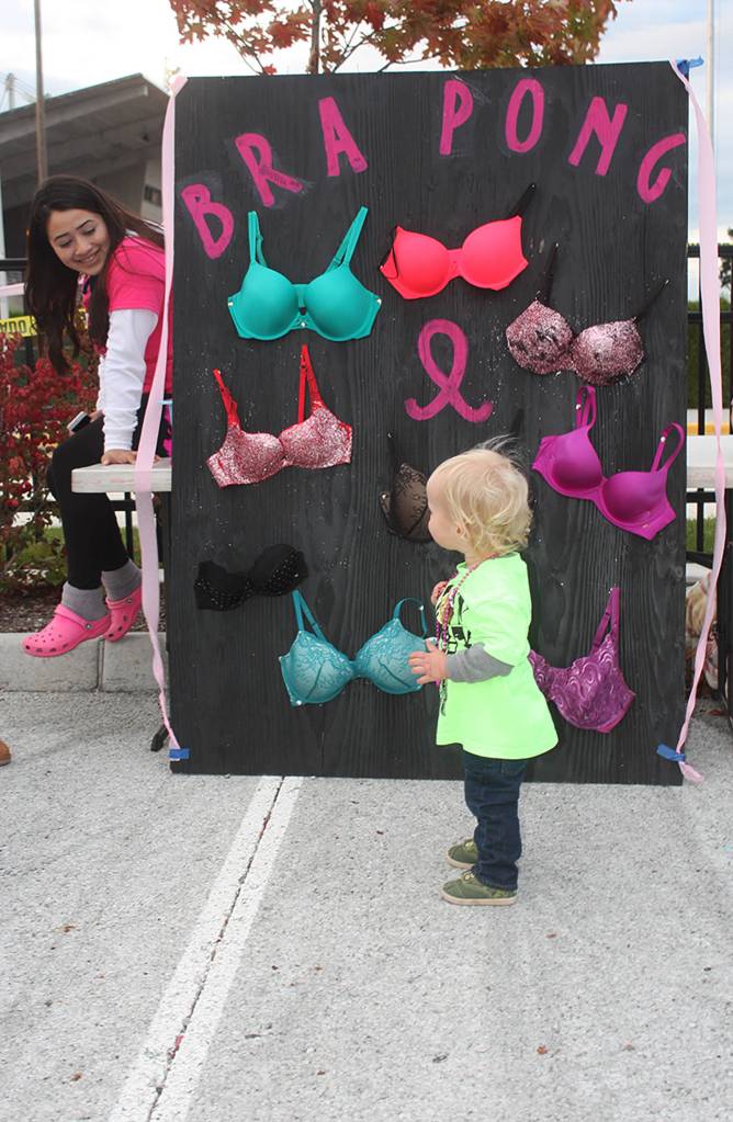 Little Charlie Morehead, 1½ years old, visits a booth during the tailgate party Friday. MARK KLAAS, Auburn Reporter