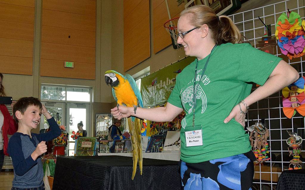 Erica Ospina shows her parrot, Jessie, to Damien Gutierrez, 7. RACHEL CIAMPI, Auburn Reporter