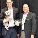 Sen. Joe Fain, with his dog Waffles, joins Greg Hanon, a WSVMA lobbyist, right, to receive his award. COURTESY PHOTO