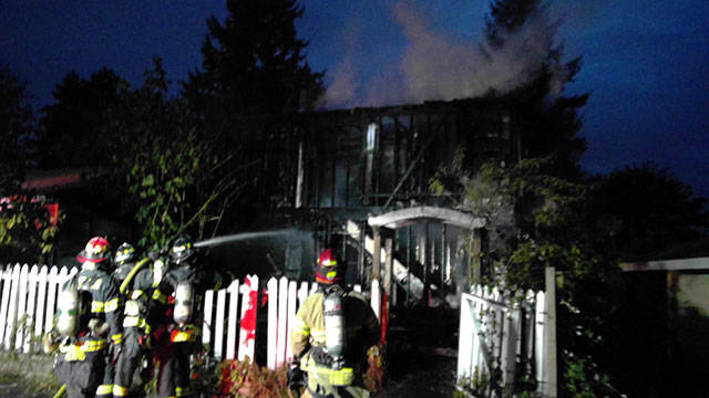 Valley Regional Fire Authority firefighters contain a two-story house fire near the 31900 block of 120th Place Southeast. COURTESY PHOTO, VRFA
