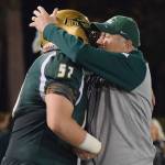 Auburn coach Gordon Elliott hugs his senior Jacob Kludsikofsky during Friday night&rsquo;s game. Elliott is retiring after a long, successful career in coaching. RACHEL CIAMPI, Auburn Reporter
