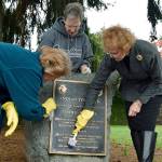 Volunteers, from left, Fran Hollums, Linda Hansen and Hilda Meryhew clean the Indian Tom Park centennial marker at Indian Tom Park on Sunday. The marker was dedicated in honored remembrance of Tom Wil-Etch-Tid for his act of compassion in saving the lives of three early pioneer children during the 1855 White River Massacre. The Auburn Rio Verde Golden &ldquo;K&rdquo; Kiwanis Club – through cooperation of Auburn Parks, Arts and Recreation Department and the Auburn Centennial Commission of 1991 – presented the marker. RACHEL CIAMPI, Auburn Reporter