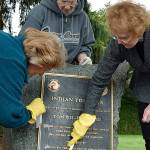 Volunteers help clean up historical markers at Auburn park