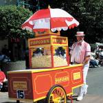 In addition to his role as a council member, Rich Wagner often has been seen at community events and parades in his fun-loving role of The Popcorn Man, pushing the bright red popcorn cart he built. REPORTER FILE PHOTO