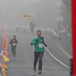 Tacomas Ben Mangrum sprints to the finish line to win Kents 35th annual Christmas Rush Fun Run at Hogan Park at Russell Road on Saturday. Mangrum completed the 10-kilometer (6.2-mile) course in 34 minutes, 13 seconds. MARK KLAAS, Kent Reporter