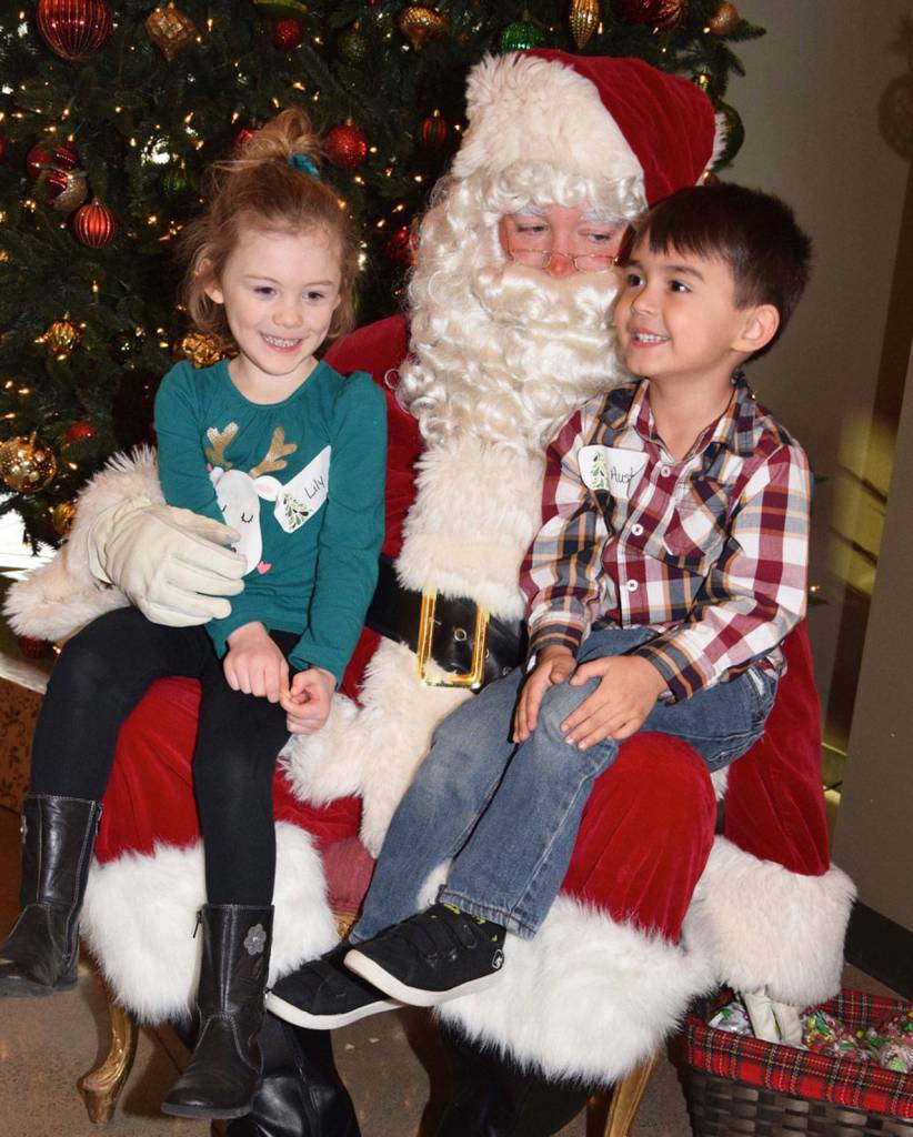 Cousins Lily Rhome, 5, and Austin Yaskus, 4, tell Santa what they want for Christmas. RACHEL CIAMPI, Auburn Reporter