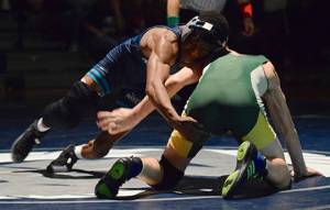 Ravens top Trojans, pin down dual season title