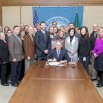 Legislation naming Washington states cancer research fund after the late Sen. Andy Hill was signed into law by Gov. Jay Inslee in Olympia. Hills wife, Molly, joined Sen. Joe Fain, who sponsored the bill, along with Hills former colleagues, legislative staff, cancer-prevention advocates and others at the ceremony. COURTESY PHOTO