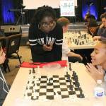 Phiona Mutesi, center, the Queen of Katwe as she is known, advises Samantha Valenzuela, left, a student at Kilo Middle School, and Tacoma Community College student Daniell Smith during a recent chess session at Family Life Community Church in Federal Way. Mutesi, the international chess champion featured in the movie, Queen of Katwe, was invited by members of the church who attend Northwest University in Kirkland with her. JESSICA KELLER, the Mirror