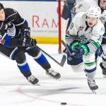 The Thunderbirds Donovan Neuls pushes the puck up the ice with the Royals Dino Kambeitz in pursuit during WHL play Saturday night. COURTESY PHOTO, Brian Liesse, T-Birds