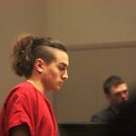 Julian Tuimauga, 18, of Auburn, enters King County Superior Court on Monday before pleading not guilty to first-degree assault and malicious harassment charges. MARK KLAAS, Reporter