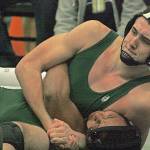 Auburns Austin Rhiel applies the squeeze to Decaturs Sampson Mitchell, pinning his opponent to take the 195-pound title at the North Puget Sound League Olympic Division League and sub-regional tournament at Todd Beamer High School last Saturday. MARK KLAAS, Auburn Reporter