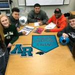 Top student athletes at Auburn Riverside High School signed college scholarships on national letter-of-intent day, Feb. 7. They were, from left: Anna Maracich (Western Washington University, volleyball); Ciera Zimmerman (Colorado State, volleyball); Isaiah Prescott (Air Force Academy, football); Tiano Malietufa (Central Washington, football); Jaden Robinson (Oregon State, football); Riley Dunne (South Dakota School of Mines Technology, soccer) and Calley Heilborn (Western Washington, volleyball). MARK KLAAS, Auburn Reporter