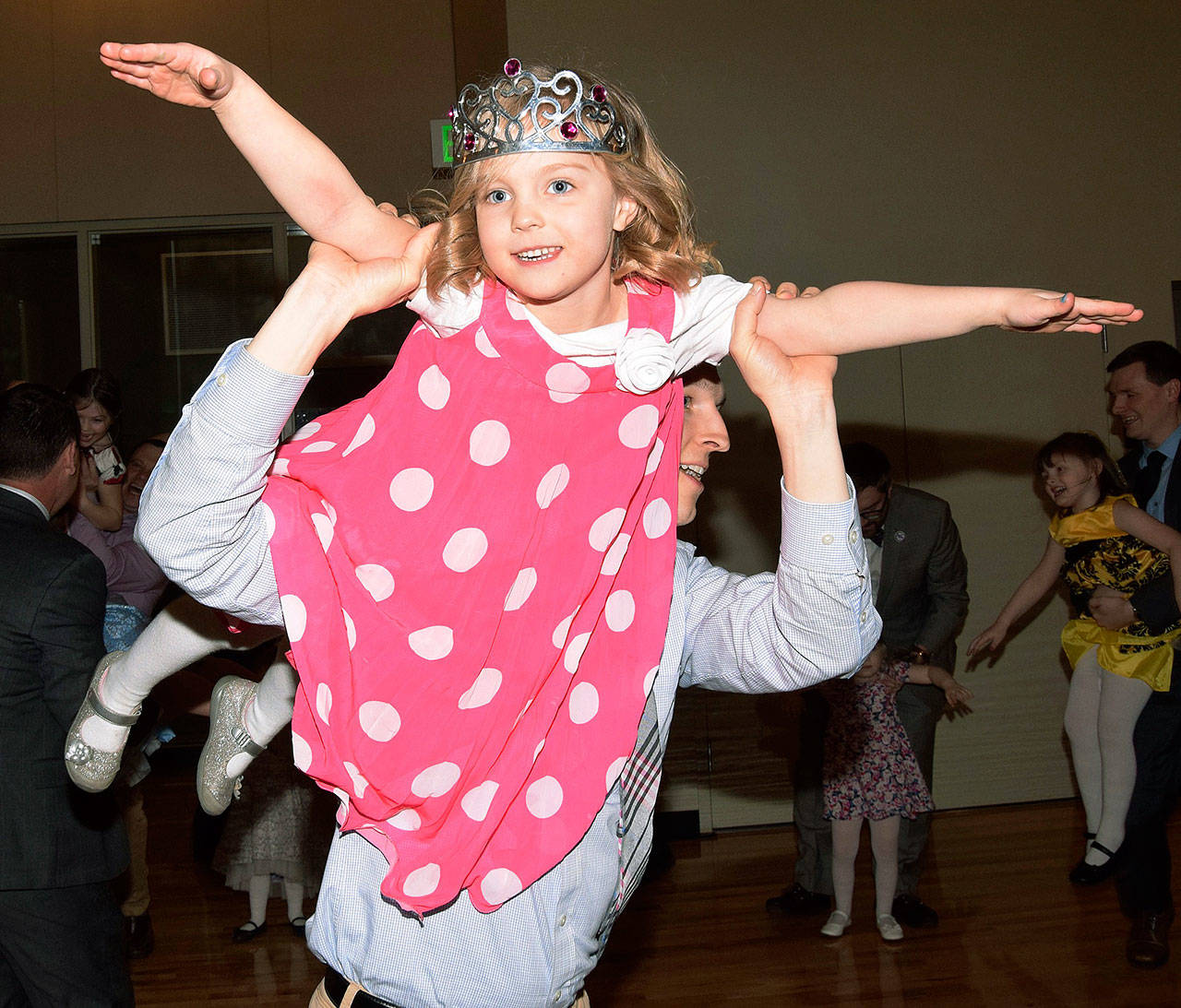 Cameron Gleed lifts his daughter, Addison, 5, above, during the Daddy Daughter Princess Ball at the Auburn Community and Event Center last Saturday. RACHEL CIAMPI, Auburn Reporter
