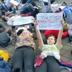Auburn-area high school students lay down in front of the City Hall for a brief moment to symbolize the limited amount of time it took gunman in Parkland, Fla., to buy an AR-15 gun, which he used to kill 17 people at a school. ROBERT WHALE, Auburn Reporter