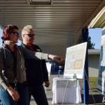 Kaleta and Erik Kingman-Gatz with their son Evan, a seventh-grader at Olympic Middle School, look at what the new school will look at during the recent groundbreaking. RACHEL CIAMPI, Auburn Reporter