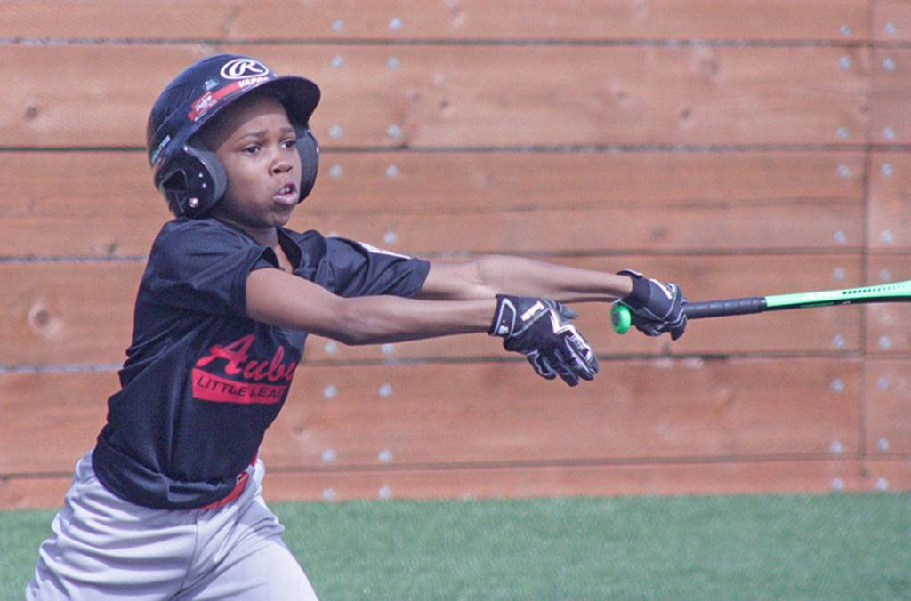 The Auburn Reds Jeriah Winston, 9, swings at a pitch during action against the Bulls. MARK KLAAS, Auburn Reporter