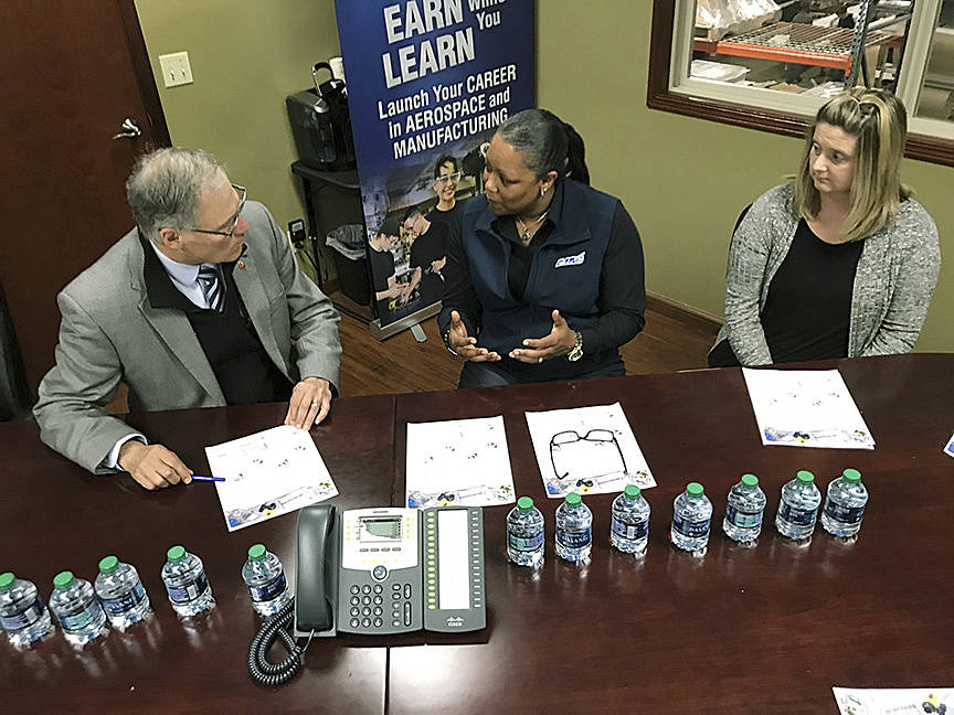 Gov. Jay Inslee listens to Lynn Strickland, executive director of Washingtons Aerospace Joint Apprenticeship Committee (AJAC) program, during his visit last Friday. MARK KLAAS, Auburn Reporter