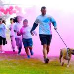 Participants charge through a color-throwing station during the Run2Educate Color Run at Buena Vista Seventh-day Adventist School on Sunday. RACHEL CIAMPI, Auburn Reporter