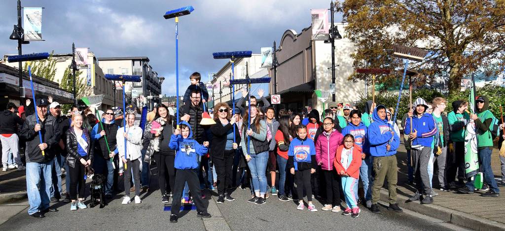 City and community leaders joined volunteers in the ceremonial Clean Sweep down Main Street last Saturday. RACHEL CIAMPI, Auburn Reporter