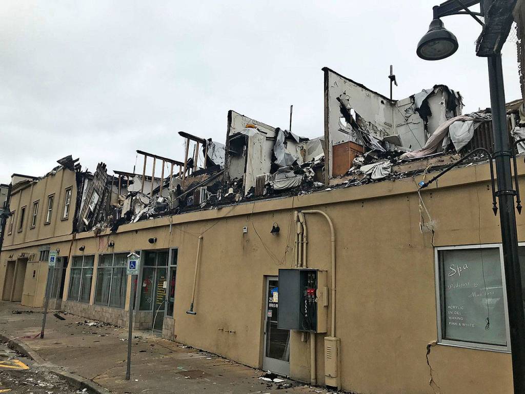 The nearly 100-year-old Heritage Building in downtown Auburn, victim of a devastating fire on Dec. 26, 2017, will come down, possibly within weeks, depending on the citys issuance of demolition permits. Its owner has already listed the property for sale. MARK KLAAS, Kent Reporter