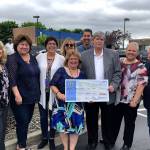 The Pennock organization donated $2,018 to the Auburn Food Bank, whose executive director, Debbie Christian, was on hand to receive the donation. COURTESY PHOTO