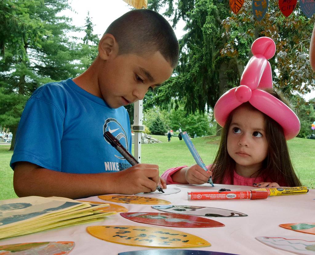 Alex Macias, 7, and Bryanna Vega, 3, create an art leaf at Kids Day. RACHEL CIAMPI, Auburn Reporter