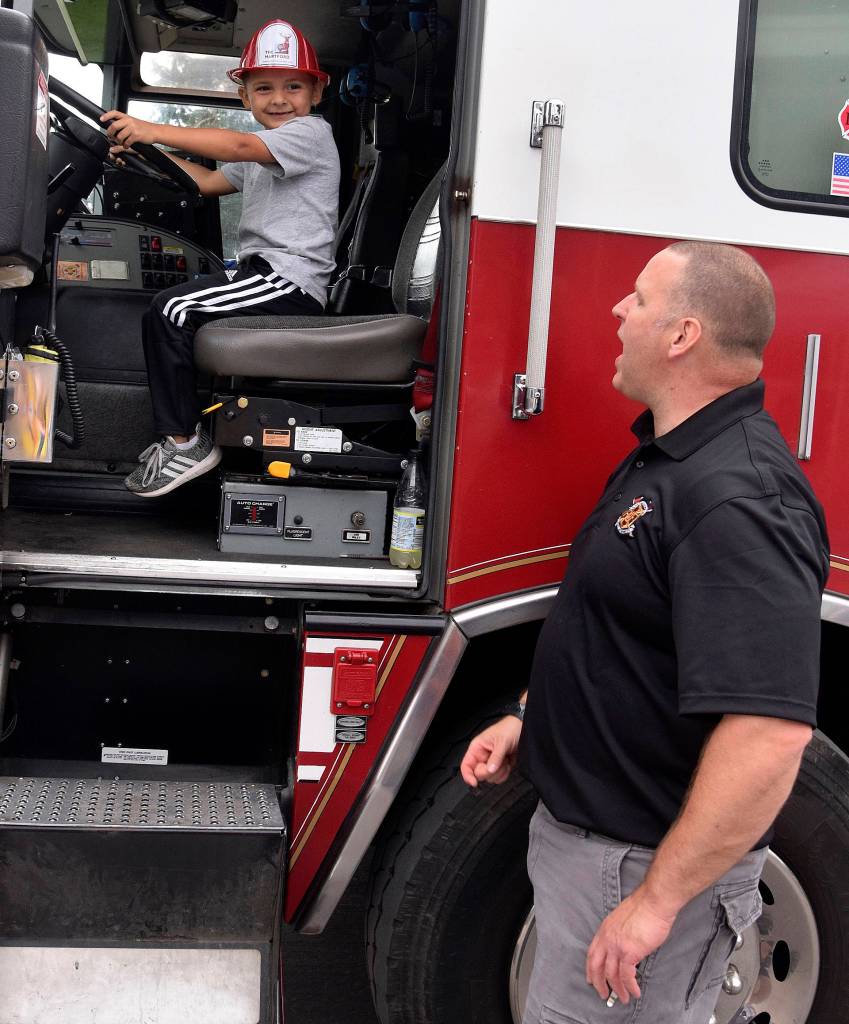 The VRFAs Daris Conrad has Dominic Canales, 5, man the fire truck.