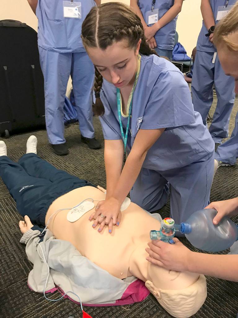 Alyssa Price, a junior-to-be at Kentlake High School, works on reviving a CPR manikin patient during Nurse Camp at Tacoma General Hospital last week. MARK KLAAS, Reporter
