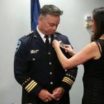 Debbie Pierson pins the badge on her husband, William Pierson, shortly after he took the oath of office to become the City of Auburns new Police Chief, Monday night at Auburn City Hall. ROBERT WHALE, Auburn Reporter