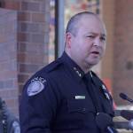Kent Police Chief Rafael Padilla delivers an update on the investigation and death of officer Diego Moreno, shown left on a poster, at a press conference Monday afternoon outside police headquarters. MARK KLAAS, Kent Reporter