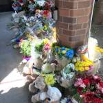 A memorial for a fallen Kent Police officer grows outside the departments headquarters Monday. Officer Diego Moreno, an eight-year veteran, was killed while helping police chase down suspects allegedly involved in a gunfire incident early Sunday morning. MARK KLAAS, Kent Reporter