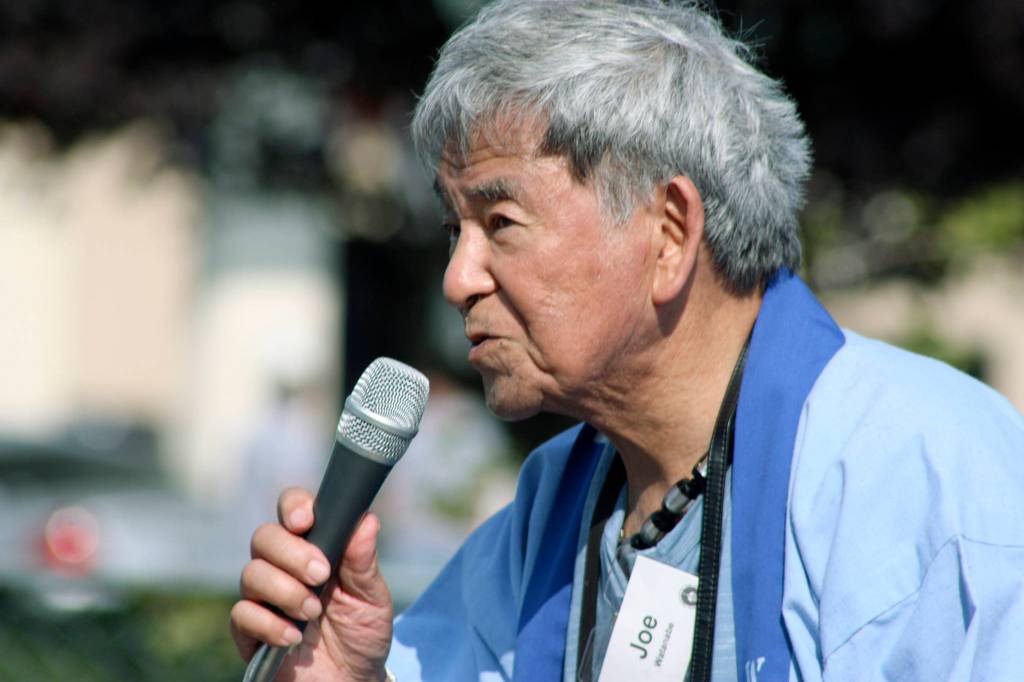 Joe Watanabe, an event organizer, delivers announcements during the Bon Odori program. MARK KLAAS, Auburn Reporter