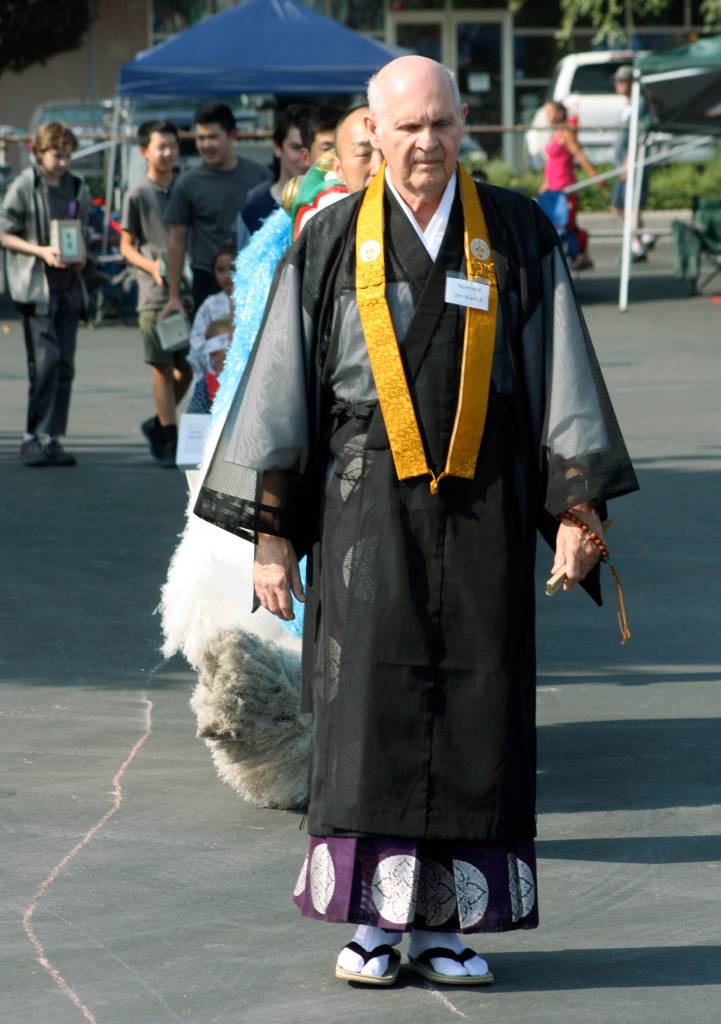 Jim Warrick, the new reverend at the White River Buddhist Temple, leads the Childrens Lantern Parade. MARK KLAAS, Auburn Reporter