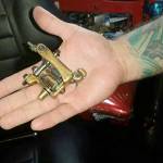 In the palm of his right hand, Rich White displays the tattoo machine he won for Tattoo of the Day at the Seattle Tattoo Expo of 2010. ROBERT WHALE, Auburn Reporter