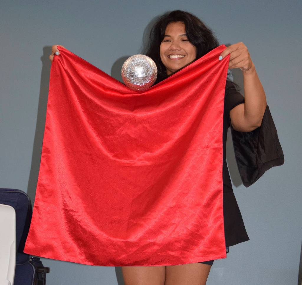 Magician Maritess Zurbano shows a trick on stage. RACHEL CIAMPI, Auburn Reporter