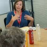 Bonnie Kosco discusses with Auburn senior citizen Joanne Harries, foreground, how a marijuana-infused lotion has helped relieve the pain of her arthritis. ROBERT WHALE, Auburn Reporter