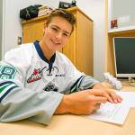 Kai Uchacz signs a WHL Standard Player Agreement with the Thunderbirds on Monday. COURTESY PHOTO, Brian Liesse, T-Birds