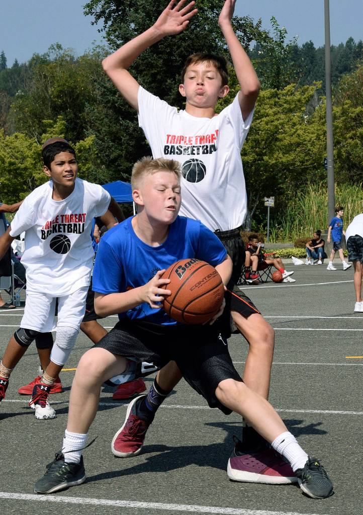 The Blue teams Jack Miller keeps the ball away from the Triple Threats Dalton Brown. RACHEL CIAMPI, Auburn Reporter