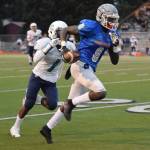 The Lions Bill Benjamin takes a pass from Drew Davenport and streaks 46 yards for a touchdown, with the Ravens Quamie Walkes in pursuit during the first half of their NPSL game Friday night. RACHEL CIAMPI, Auburn Reporter