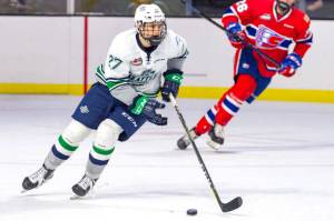 The Thunderbirds Payton Mount pushes the puck up the Ice during WHL preseason against Spokane on Sunday. COURTESY PHOTO, Brian Liesse, T-Birds